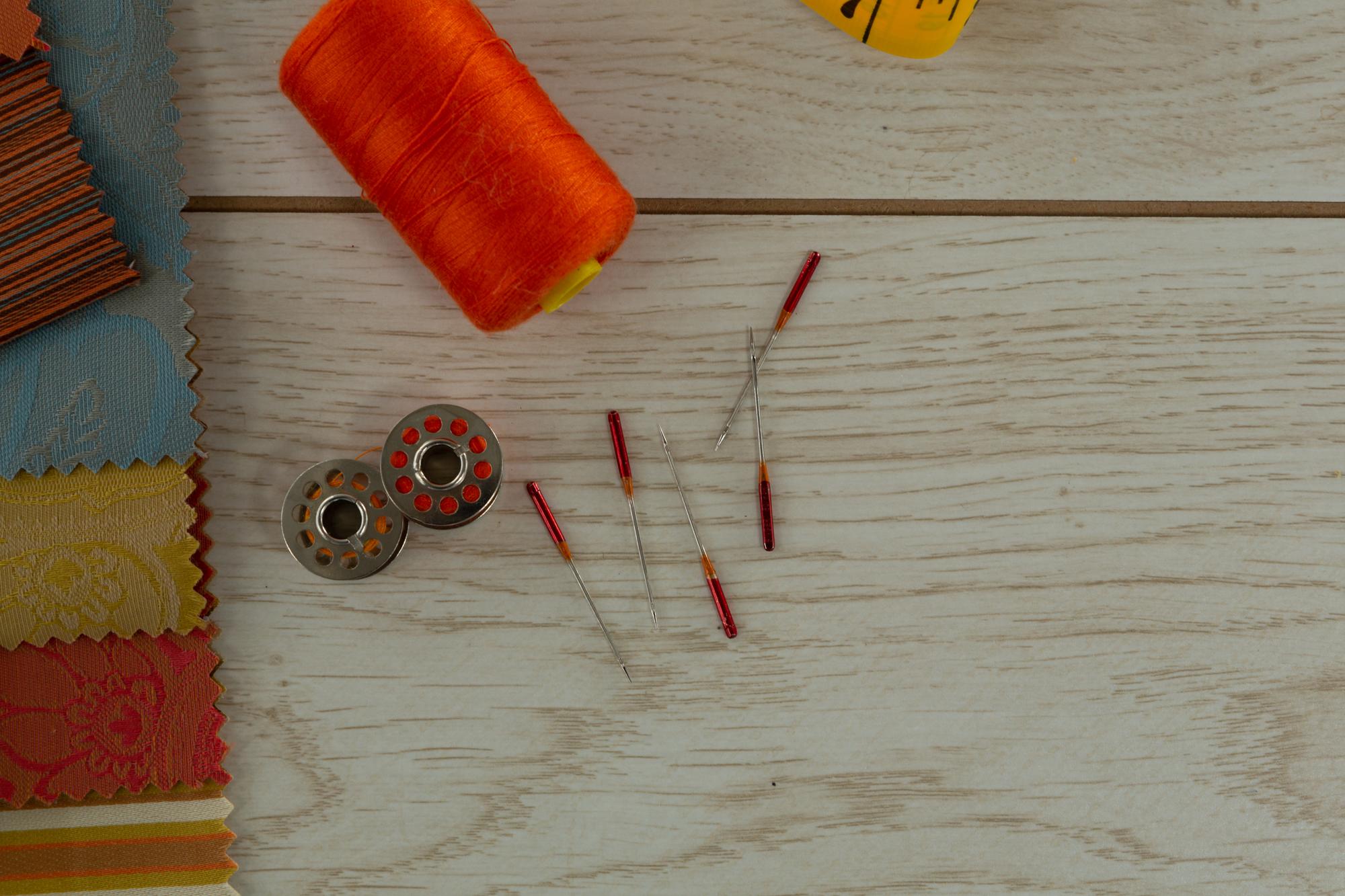 studio table with thread spools and sample patches